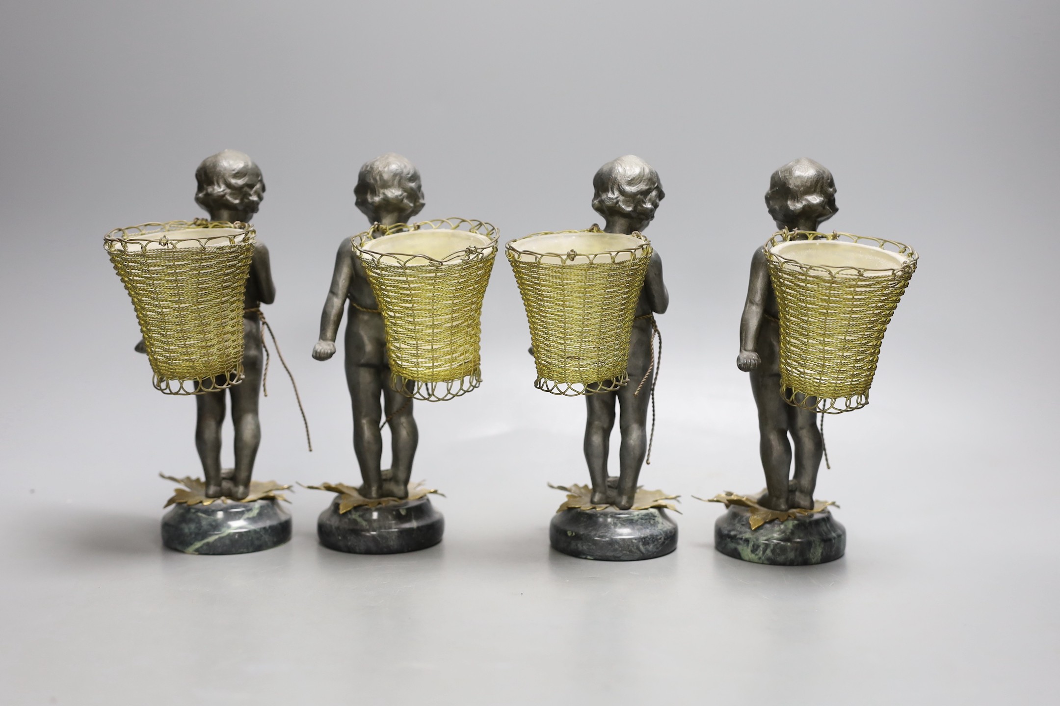 Four spelter and gilt metal ‘cherub’ posy vases, with glass liners, serpentine bases - 19cm tall